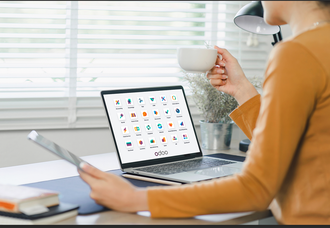 Person reviewing the full Odoo apps dashboard on a laptop, including Quality, Manufacturing, and Inventory modules, illustrating Odoo's integrated platform for turning quality data into executive intelligence